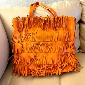 Guia’s orange fringe leather bag